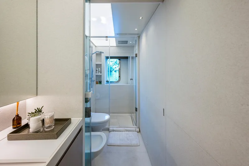 Mr. D Yacht Photos Pics Luxurious bathroom on 2015 Benetti 140 yacht, featuring modern design and elegant fixtures.