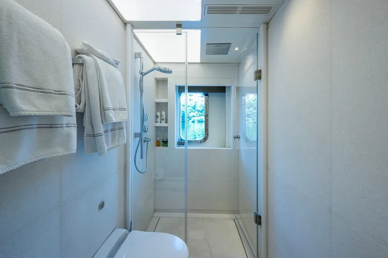 Mr. D Yacht Photos Pics Luxurious bathroom on 2015 Benetti 140 yacht with shower and window view.