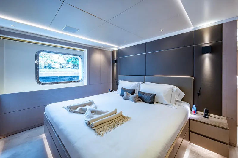 Mr. D Yacht Photos Pics Luxurious bedroom interior on 2015 Benetti 140 yacht, featuring modern design and large window.