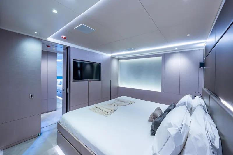 Mr. D Yacht Photos Pics Luxurious bedroom interior on 2015 Benetti 140 yacht, featuring modern design and ambient lighting.