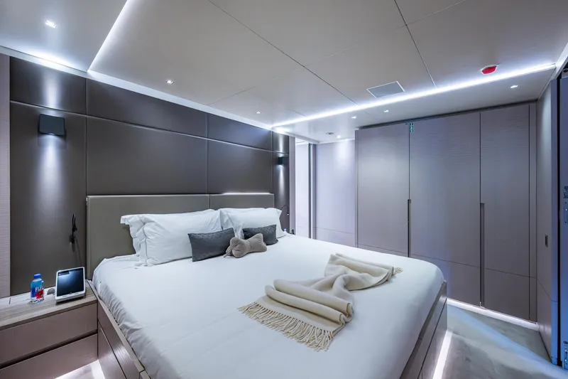 Mr. D Yacht Photos Pics Luxurious bedroom interior on a 2015 Benetti 140 yacht, featuring modern design and ambient lighting.
