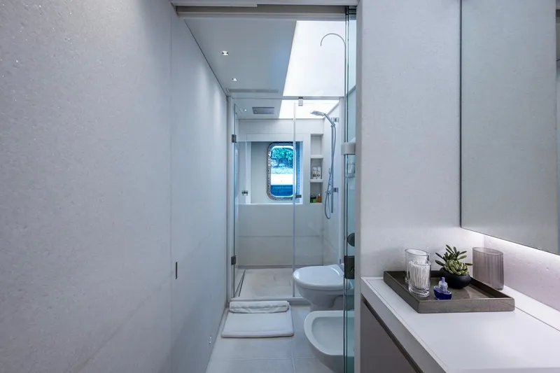 Mr. D Yacht Photos Pics Luxurious bathroom on 2015 Benetti 140 yacht, featuring modern design and elegant fixtures.