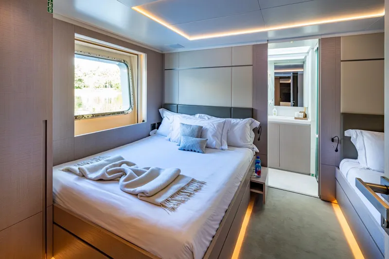 Mr. D Yacht Photos Pics Luxurious bedroom interior on 2015 Benetti 140 yacht, featuring modern design and cozy ambiance.
