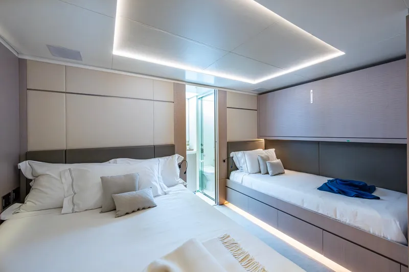 Mr. D Yacht Photos Pics Luxurious bedroom interior on 2015 Benetti 140 yacht, featuring modern design and elegant lighting.