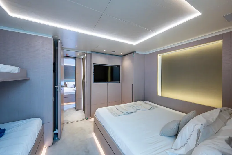 Mr. D Yacht Photos Pics Luxurious bedroom interior on 2015 Benetti 140 yacht, featuring modern design and ambient lighting.