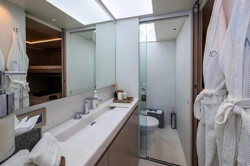 Mr. D Yacht Photos Pics Luxurious bathroom on 2015 Benetti 140 yacht, featuring modern fixtures and plush robes.
