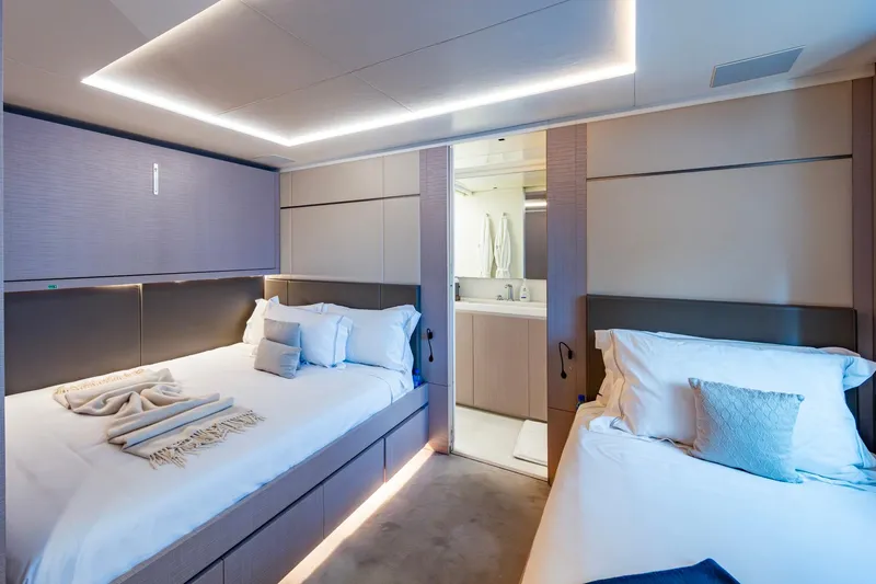 Mr. D Yacht Photos Pics Luxurious bedroom interior on 2015 Benetti 140 yacht, featuring modern design and ambient lighting.