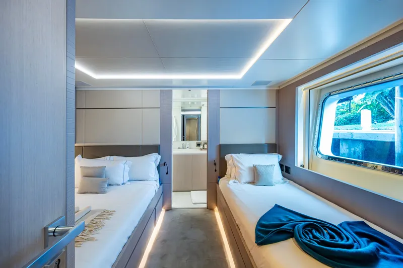 Mr. D Yacht Photos Pics Luxurious twin cabin interior on 2015 Benetti 140 yacht, featuring modern design and large window.
