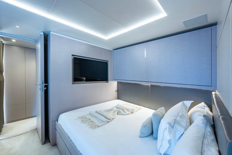 Mr. D Yacht Photos Pics Luxurious bedroom interior on 2015 Benetti 140 yacht, featuring modern design and ambient lighting.