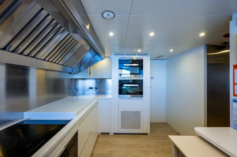 Mr. D Yacht Photos Pics Modern kitchen interior on 2015 Benetti 140 yacht, featuring sleek appliances and stainless steel finishes.