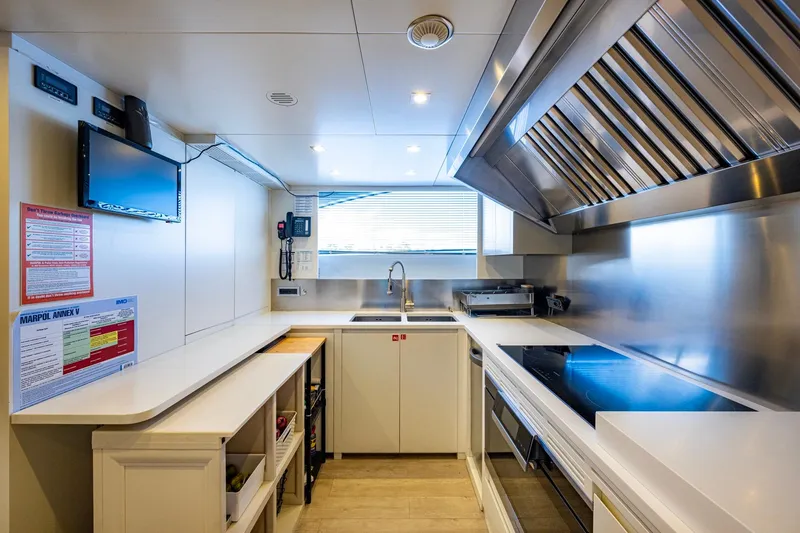 Mr. D Yacht Photos Pics Modern kitchen interior on 2015 Benetti 140 yacht, featuring sleek appliances and ample counter space.