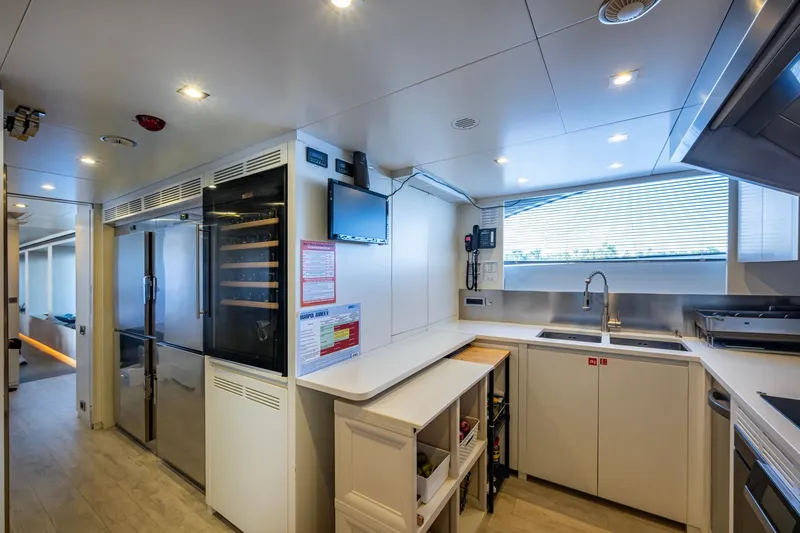 Mr. D Yacht Photos Pics Modern kitchen interior on a 2015 Benetti 140 yacht, featuring sleek appliances and ample counter space.