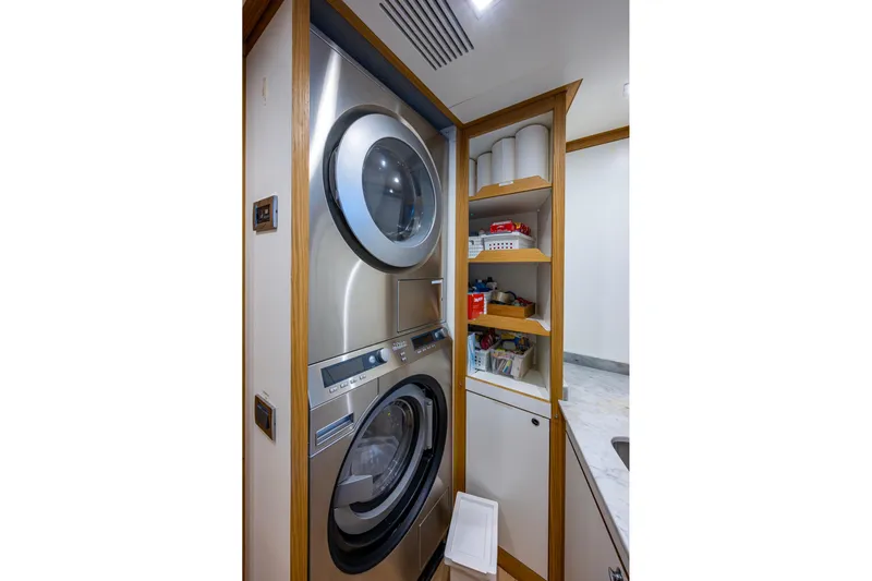 Mr. D Yacht Photos Pics Laundry area on 2015 Benetti 140 yacht with stacked washer and dryer.