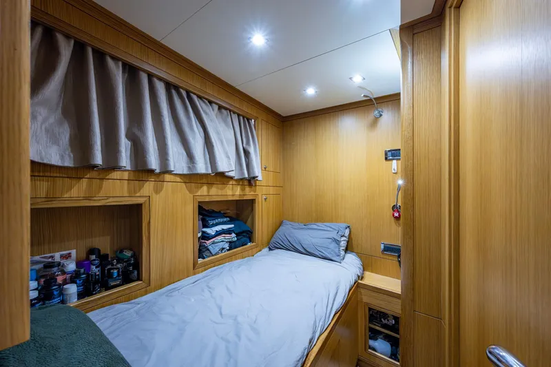 Mr. D Yacht Photos Pics Cozy cabin interior of 2015 Benetti 140 yacht with wooden paneling and single bed.