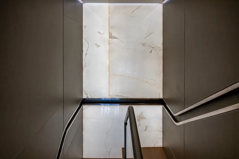 Mr. D Yacht Photos Pics Luxurious interior staircase of 2015 Benetti 140 yacht with elegant marble wall design.
