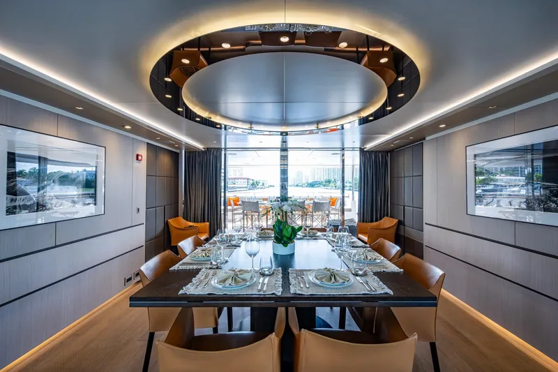 Mr. D Yacht Photos Pics Luxurious dining area on a 2015 Benetti 140 yacht, featuring elegant table settings and modern decor.