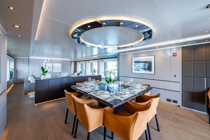Mr. D Yacht Photos Pics Luxurious dining area on a 2015 Benetti 140 yacht with elegant decor and modern furnishings.