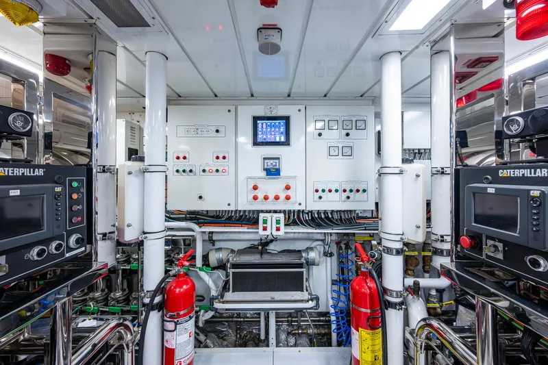 Mr. D Yacht Photos Pics Engine room of 2015 Benetti 140 yacht with control panels and fire extinguishers.