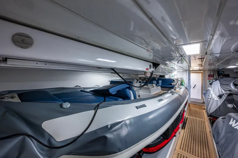 Mr. D Yacht Photos Pics Storage area of a 2015 Benetti 140 yacht with inflatable boat and equipment.