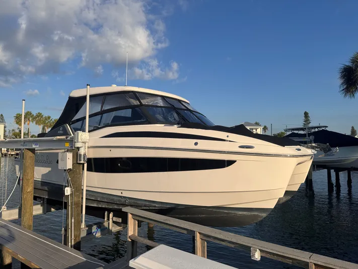  Yacht Photos Pics 2023 Aquila 32 Sport boat docked at marina under clear blue sky.