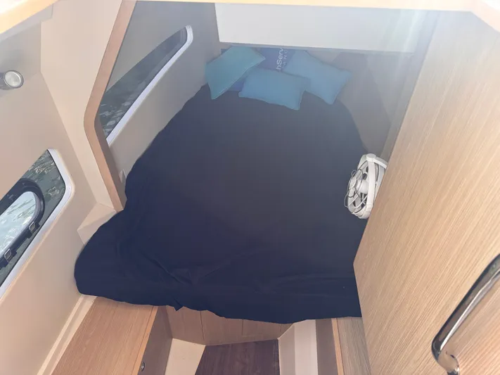  Yacht Photos Pics 2023 Aquila 32 Sport cabin interior with bed, pillows, and fan.