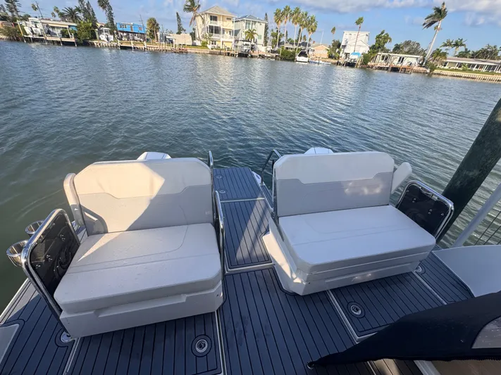  Yacht Photos Pics 2023 Aquila 32 Sport boat with dual seating on a sunny waterfront.