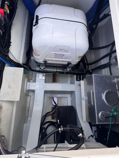  Yacht Photos Pics Engine compartment of 2023 Aquila 32 Sport boat, featuring generator and wiring.