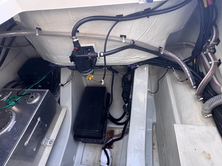  Yacht Photos Pics Engine compartment of 2023 Aquila 32 Sport boat, showcasing wiring and components.
