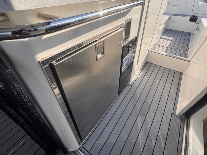  Yacht Photos Pics 2023 Aquila 32 Sport boat interior with stainless steel appliance and sleek flooring.