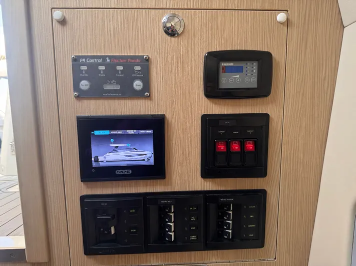  Yacht Photos Pics Control panel of 2023 Aquila 32 Sport boat with various electronic displays and switches.