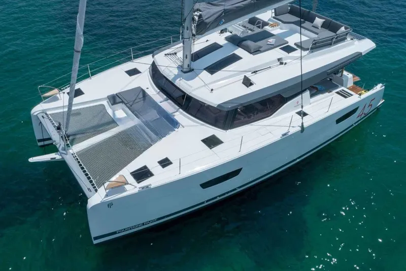  Yacht Photos Pics 2025 Fountaine Pajot Elba 45 catamaran sailing on clear blue water.