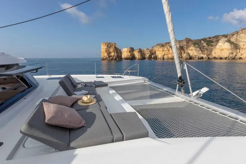  Yacht Photos Pics Luxurious 2025 Fountaine Pajot Elba 45 catamaran with scenic coastal view.