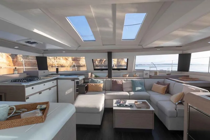  Yacht Photos Pics Luxurious interior of 2025 Fountaine Pajot Elba 45 catamaran with modern design and spacious seating.
