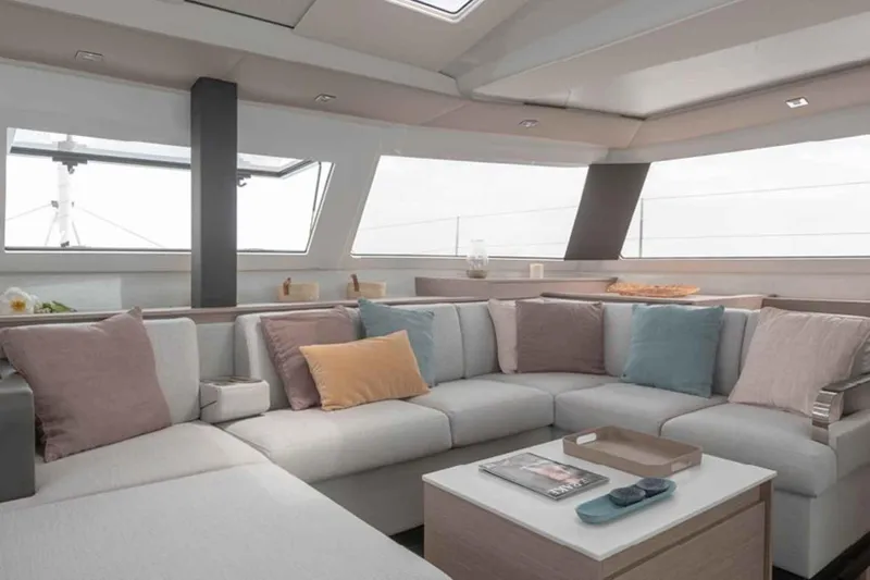  Yacht Photos Pics Luxurious interior of 2025 Fountaine Pajot Elba 45 catamaran with modern seating and decor.