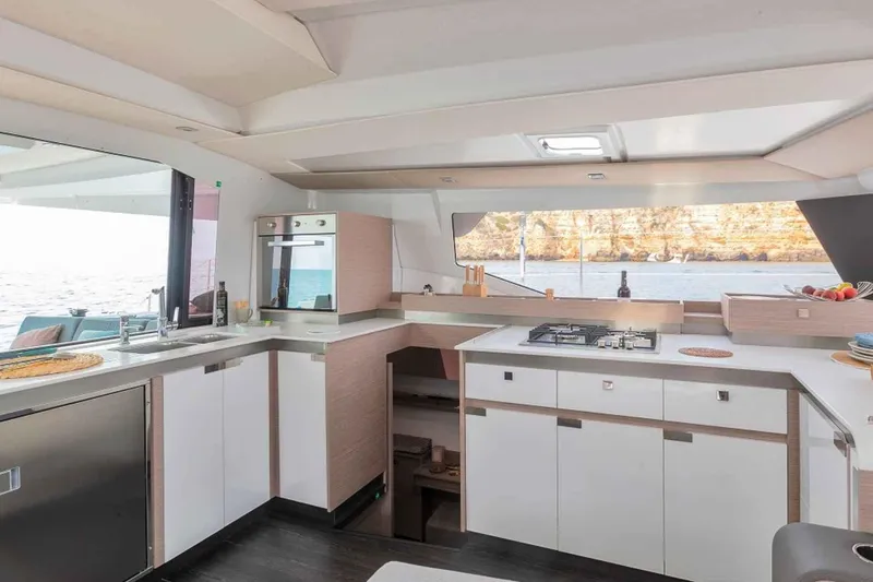 Yacht Photos Pics Modern kitchen interior of 2025 Fountaine Pajot Elba 45 catamaran with ocean view.