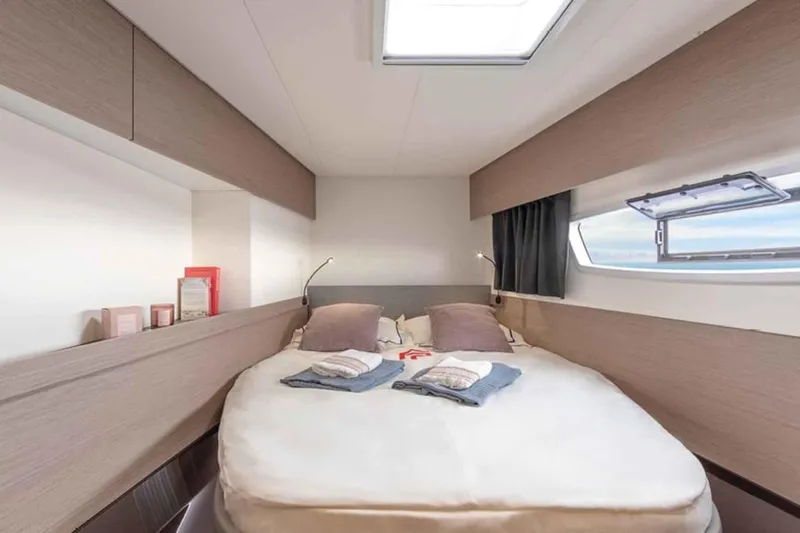  Yacht Photos Pics Luxurious cabin interior of 2025 Fountaine Pajot Elba 45 catamaran with cozy bedding.