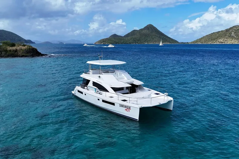 Somewhere Hot Yacht Photos Pics 2014 Leopard 51 Powercat yacht on clear blue water with scenic island backdrop.