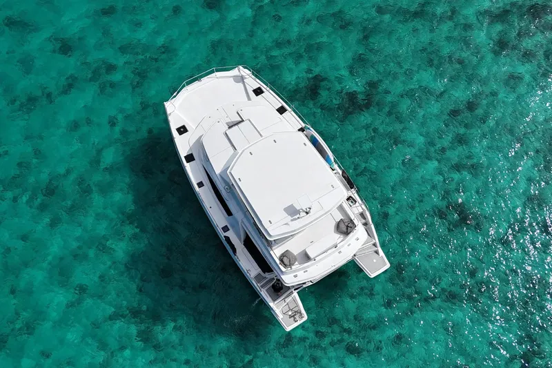 Somewhere Hot Yacht Photos Pics Aerial view of 2014 Leopard 51 Powercat on turquoise water.