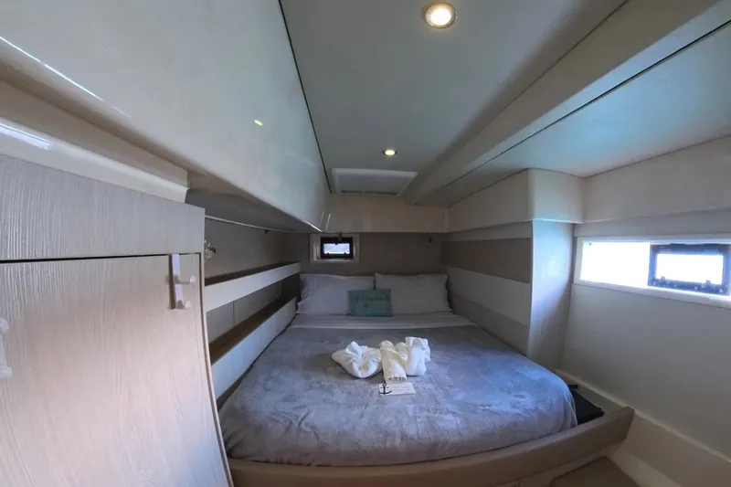 Somewhere Hot Yacht Photos Pics Luxurious cabin interior of 2014 Leopard 51 Powercat with cozy bed and modern design.