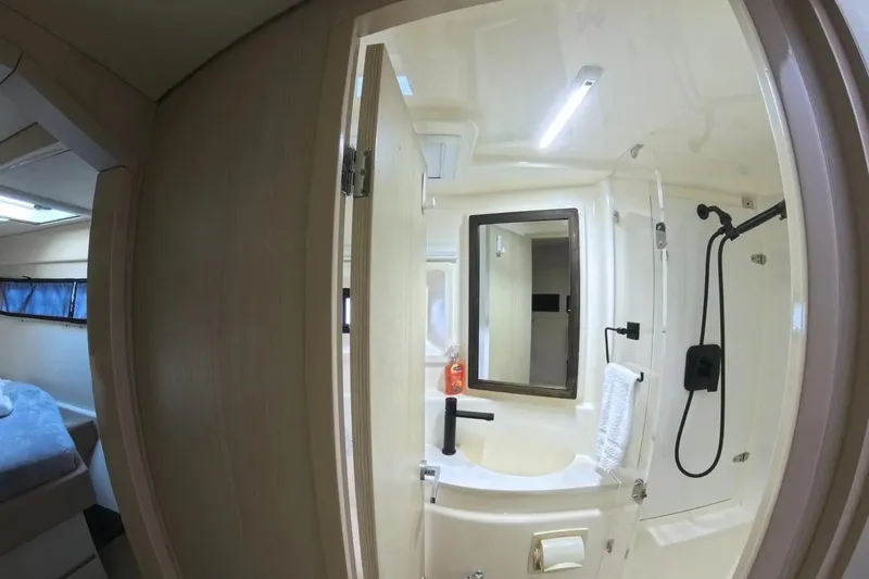 Somewhere Hot Yacht Photos Pics Interior of 2014 Leopard 51 Powercat bathroom with modern fixtures and shower.