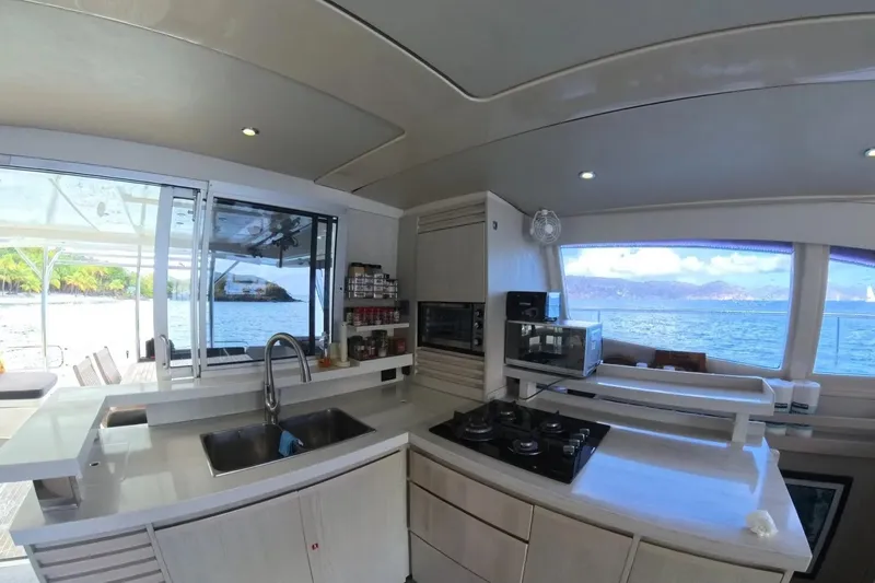 Somewhere Hot Yacht Photos Pics Luxurious kitchen interior of 2014 Leopard 51 Powercat yacht with ocean view.