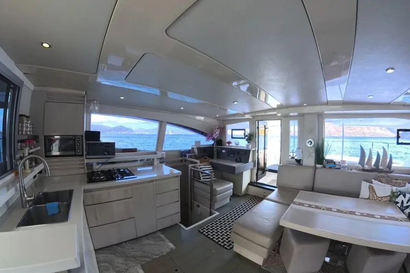 Somewhere Hot Yacht Photos Pics Luxurious interior of 2014 Leopard 51 Powercat yacht with modern kitchen and scenic ocean view.