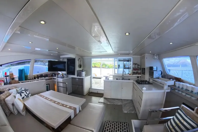 Somewhere Hot Yacht Photos Pics Luxurious interior of 2014 Leopard 51 Powercat yacht with modern kitchen and seating area.