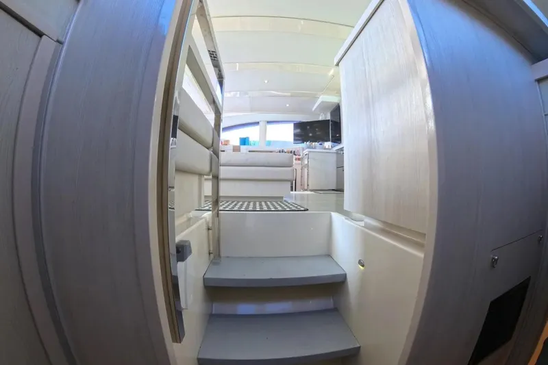 Somewhere Hot Yacht Photos Pics Interior view of 2014 Leopard 51 Powercat yacht, featuring modern stairs and sleek design.