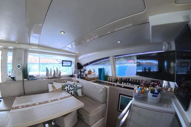 Somewhere Hot Yacht Photos Pics Luxurious interior of 2014 Leopard 51 Powercat yacht with elegant seating and scenic ocean view.