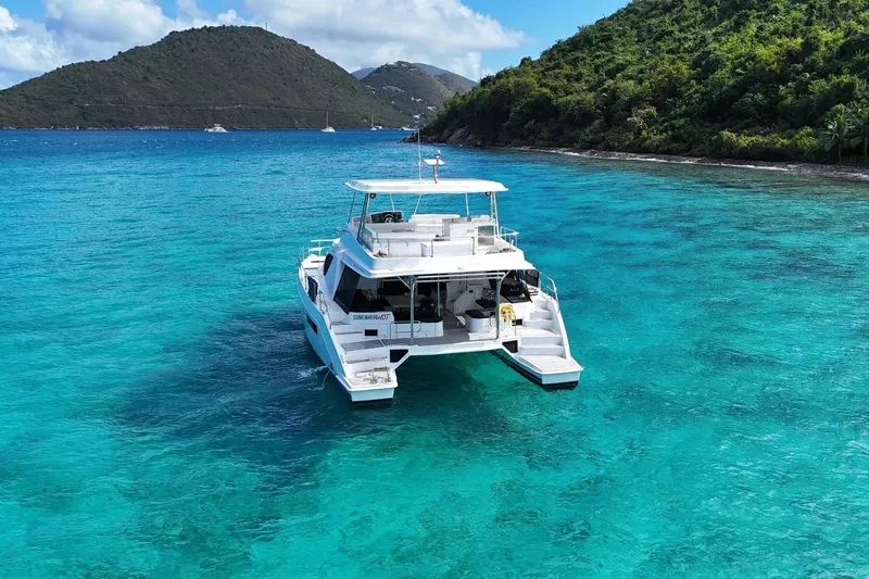 Somewhere Hot Yacht Photos Pics 2014 Leopard 51 Powercat yacht on turquoise waters near lush green islands.