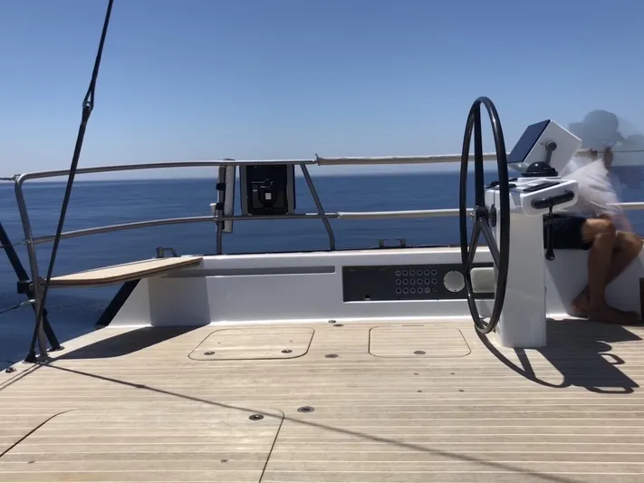 Dark Horse Yacht Photos Pics Nautor Swan 80 FD yacht deck with steering wheel, 2013 model, sailing on open sea.