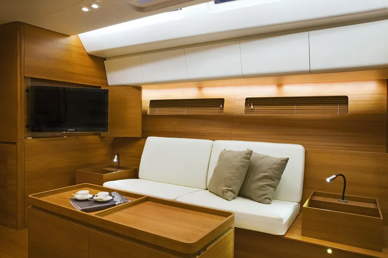 Dark Horse Yacht Photos Pics Luxurious interior of 2013 Nautor Swan 80 FD yacht with modern wood finish and cozy seating.