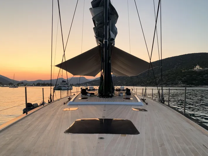 Dark Horse Yacht Photos Pics Nautor Swan 80 FD yacht deck at sunset, 2013 model, serene waterscape.