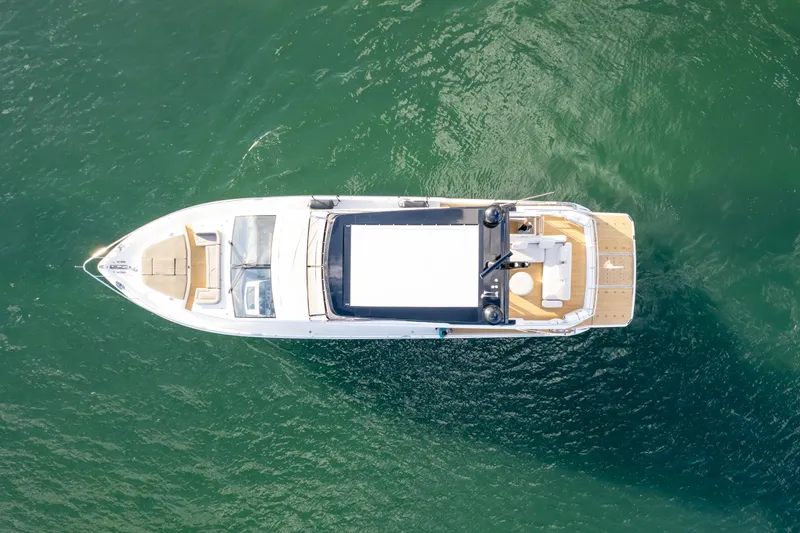  Yacht Photos Pics Aerial view of 2020 Pearl 80 yacht on green water.